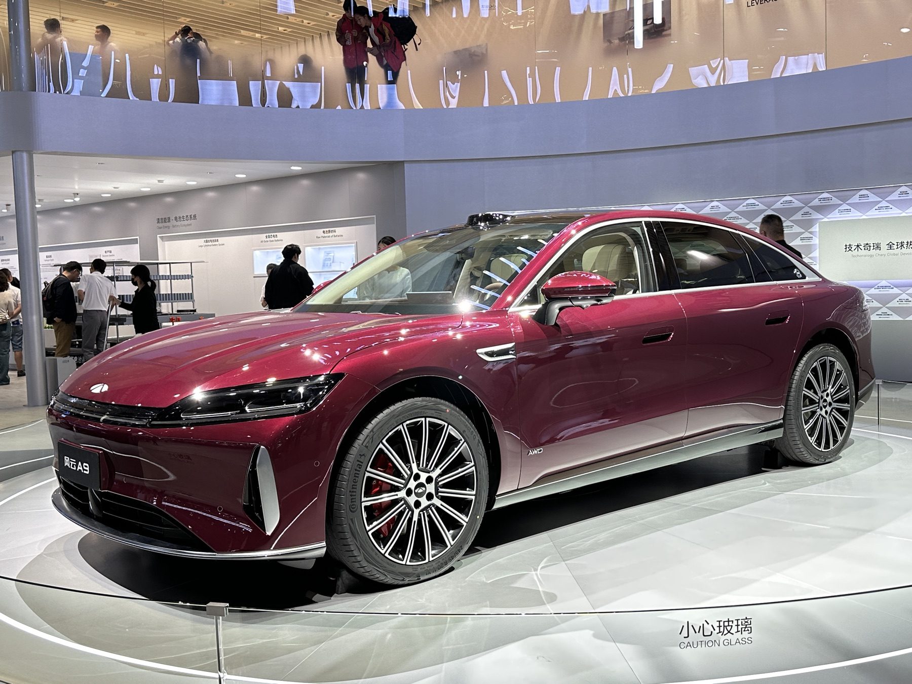 Red Chery Fulwin A9 on a motor-show stand, front three-quarter view