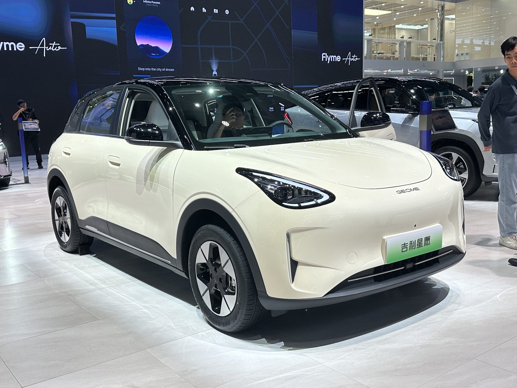White Geely Xingyuan on a motor-show stand, front three-quarter view