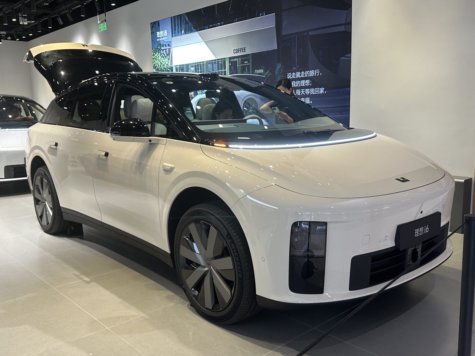 White Li Auto i6 on display, front three-quarter view